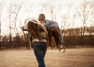 Dad carries two daughters over his shoulders during family photo session in Blair, ne