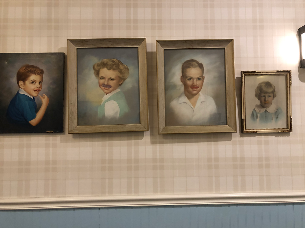 Hanging portraits of children with mustaches in the Graduate Hotel in Lincoln, NE