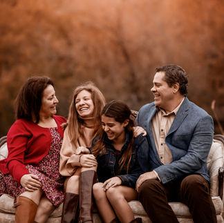 Family on a vintage couch on a hill during fall family