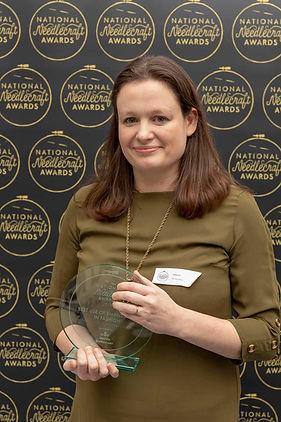 a portrait of Emma Astle with an embroidery award