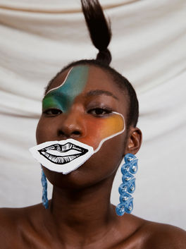 A photograph of a model with editorial artistic makeup and illustrated lips