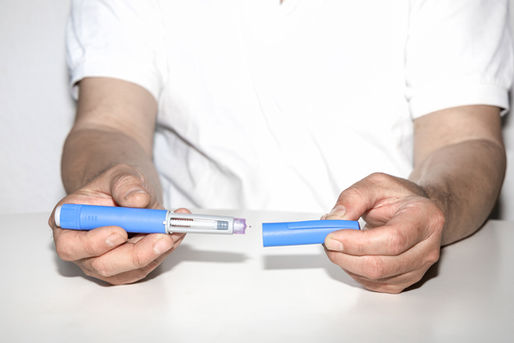 A person with an insulin pen
