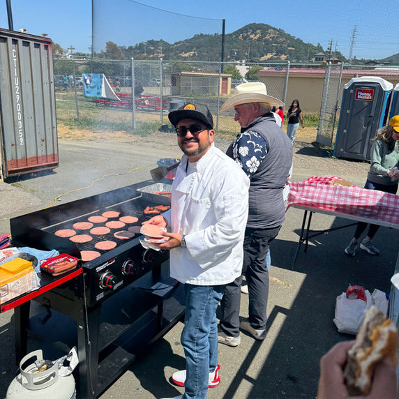 Chef grilling hamburgers at an outdoor event