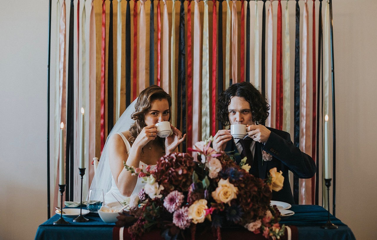 Un-Traditional Wedding Stylists alternative wedding decor blending Bridgerton and Emo styles, featuring bold moody colours, luxury velvet textiles, and dark ribbon details.