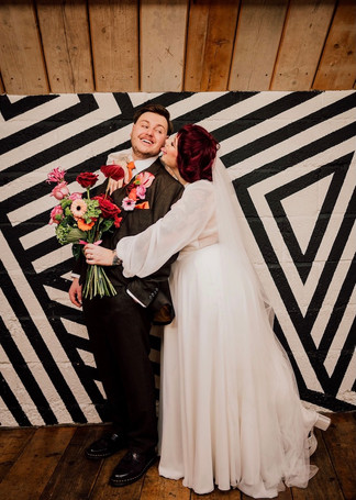 alternative wedding decor, alternative wedding stylists, pink and orange wedding styling, The Shack Revolution wedding venue, bold colourful wedding flowers, Streamadelica ceiling streamers, rockstar wedding welcome sign, burgundy and peach wedding colours, non-traditional wedding design, vibrant wedding photography UK