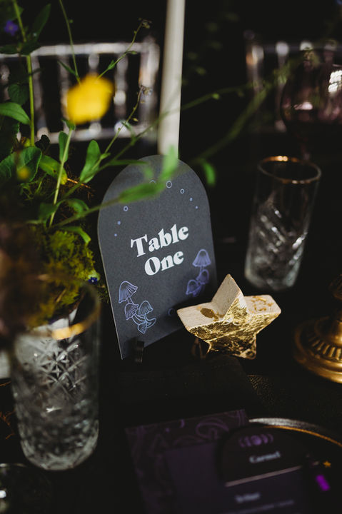 Alternative wedding styling UK, Rock n’ Roll wedding, Gothic wedding decor, Moody wedding aesthetic, Edgy bridal style, Till Death Do Us Part theme, Dark romance wedding, Unconventional wedding stylist, Bold wedding colours, Modern gothic wedding, Black tapered candles, Checkered wedding decor, Velvet wedding linens, Neon wedding signs, Industrial wedding venue, Black wedding dress, Biker jacket bride, Skull wedding details, Deep red floral design, Dark autumnal wedding flowers, Vintage suitcase decor, UK alternative wedding planner, Creative wedding stylist London, Industrial warehouse wedding UK, Quirky wedding decor hire, Edgy UK wedding inspiration, Non-traditional wedding ideas, Gothic ceremony styling, Textured floral arrangements, Moody banquet table.