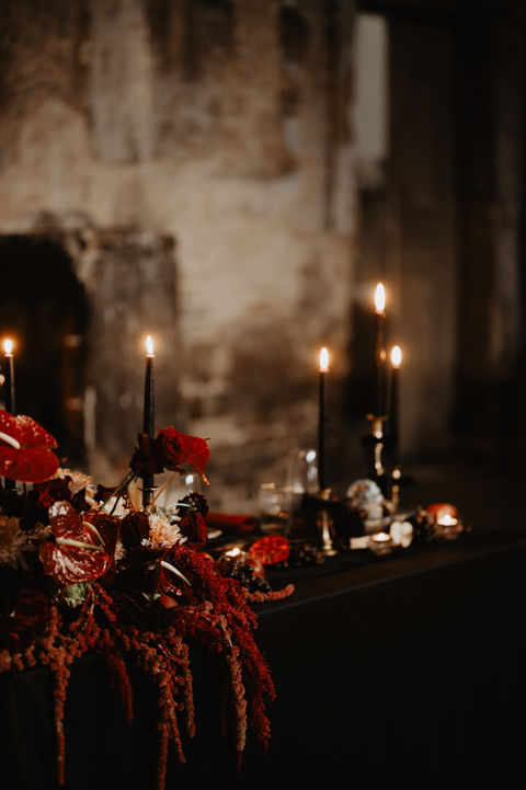 Alternative wedding styling UK, Rock n’ Roll wedding, Gothic wedding decor, Moody wedding aesthetic, Edgy bridal style, Till Death Do Us Part theme, Dark romance wedding, Unconventional wedding stylist, Bold wedding colours, Modern gothic wedding, Black tapered candles, Checkered wedding decor, Velvet wedding linens, Neon wedding signs, Industrial wedding venue, Black wedding dress, Biker jacket bride, Skull wedding details, Deep red floral design, Dark autumnal wedding flowers, Vintage suitcase decor, UK alternative wedding planner, Creative wedding stylist London, Industrial warehouse wedding UK, Quirky wedding decor hire, Edgy UK wedding inspiration, Non-traditional wedding ideas, Gothic ceremony styling, Textured floral arrangements, Moody banquet table.