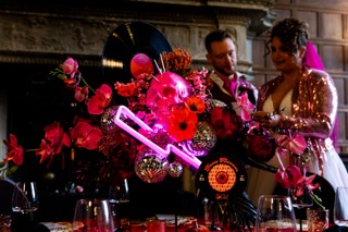 Alternative wedding flowers styled in a bold, sculptural floral installation using vibrant colours and non-traditional textures