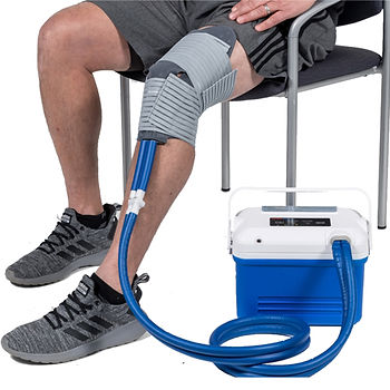 Man with knee compression therapy device, cold and heat compression therapy.