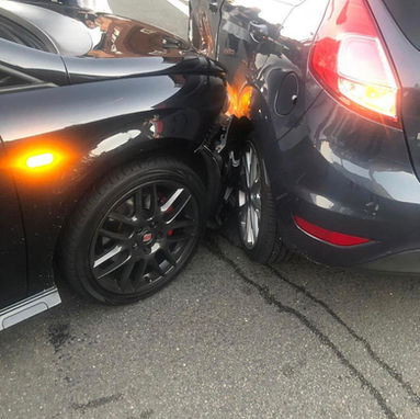 Black car smashed into side of grey one