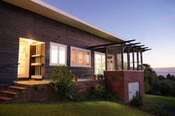 Black Wood Stained Weather boards and white enameled windows. A Very Kiwi Tradition.