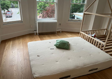Spotless bedroom with a neatly made bed and organized decor, prepared for new residents.