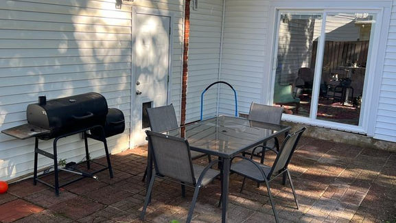 Clean outdoor dining table with a spotless floor, showcasing a tidy and welcoming outdoor dining space.