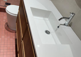 Immaculate bathroom with clean toilet and sinks, showcasing a fresh and hygienic environment.