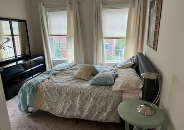 A freshly cleaned bedroom with neatly made bed and tidy surroundings, promoting a peaceful and relaxing atmosphere.