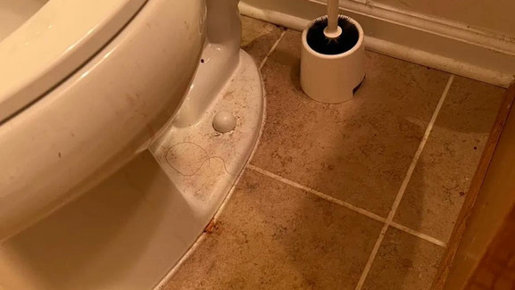 Toilet with visible stains and grime, showing an unclean and unsanitary condition.