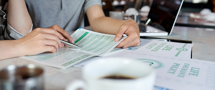 cropped-people-studying-life-insurance-brochure.jpg