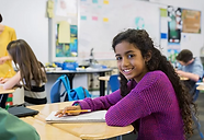 Young girl sitting at her desk in class.