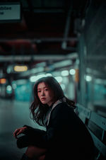 Woman sitting on a subway bench for Clien 2025