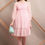 Thumbnail: A girl in pink one piece dress carrying a blue handbag