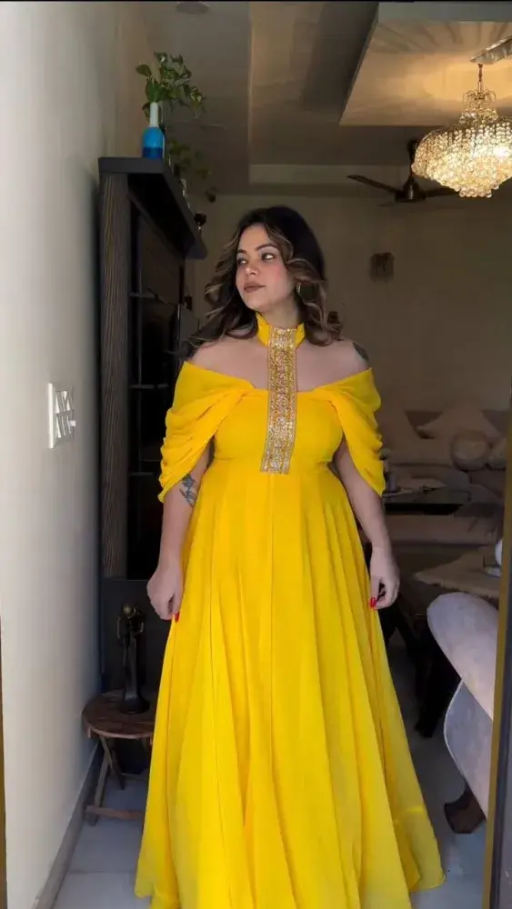 A women in Yellow Faux Georgette Gown With Big Flair and Fancy Neck