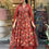 Thumbnail: A Women in Red Cotton Anarkali Printed Kurta with Pant & Dupatta Suit