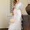 Thumbnail: A Women in Fancy White organza Silk Party wear Ruffle Saree With Purse in Hand