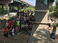 20 volunteers gather around the new pour of the killar pillar