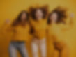 young-excited-women-jumping-together-yellow-background.jpg