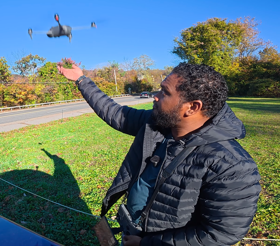 Hand launching DJI Mavic 4 Pro drone in autumn outdoor setting