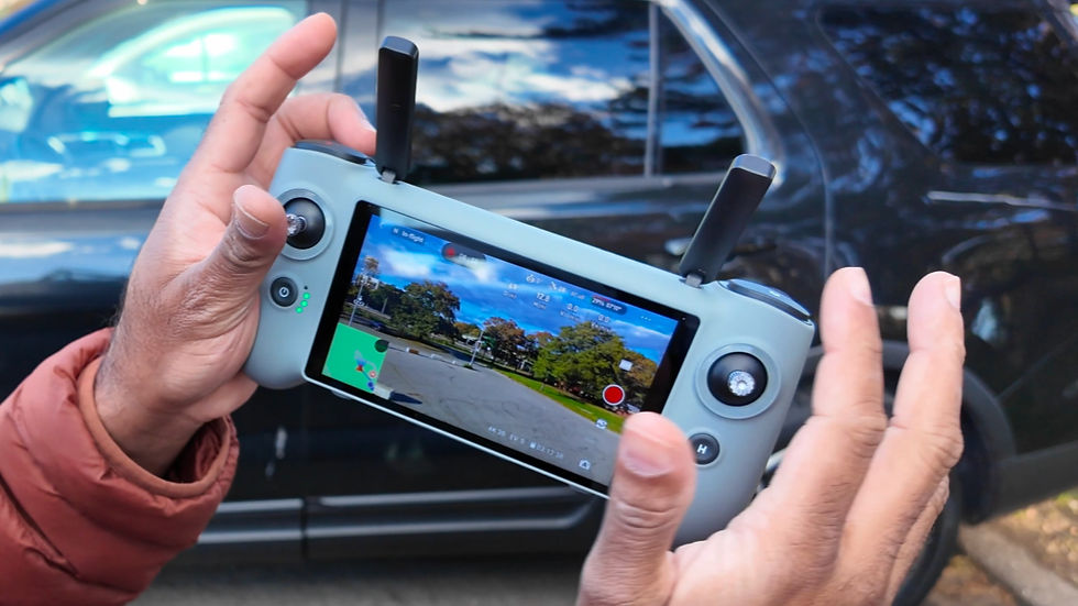 Hands holding Potensic PTD-1 controller with bright 5.5 inch display visible outdoors