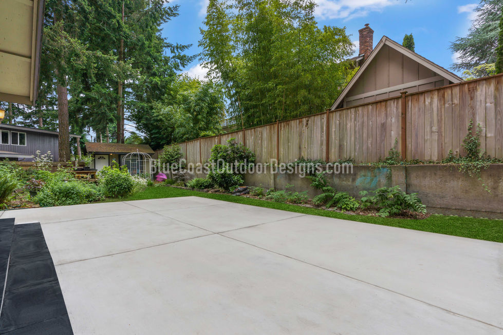 modern concrete patio and new wooden fence installation in University Place, WA.