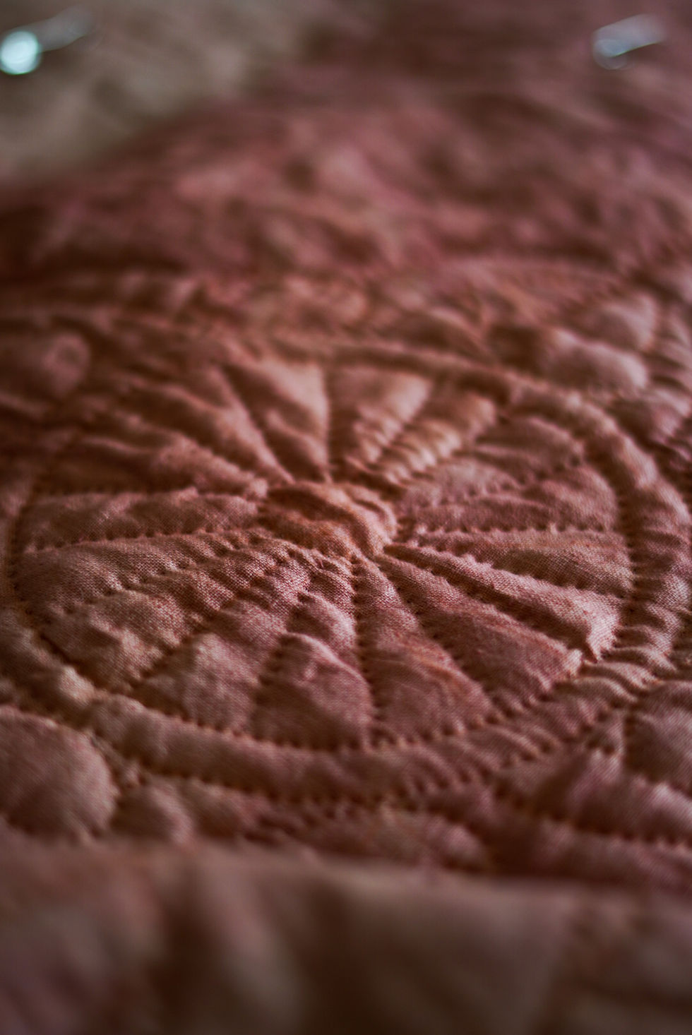 Detail of Madder-dyed hand quilted quilt.