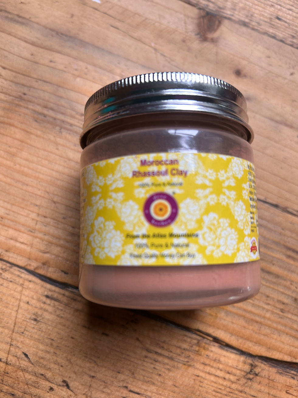 labelled jar with metal lid on wooden surface
