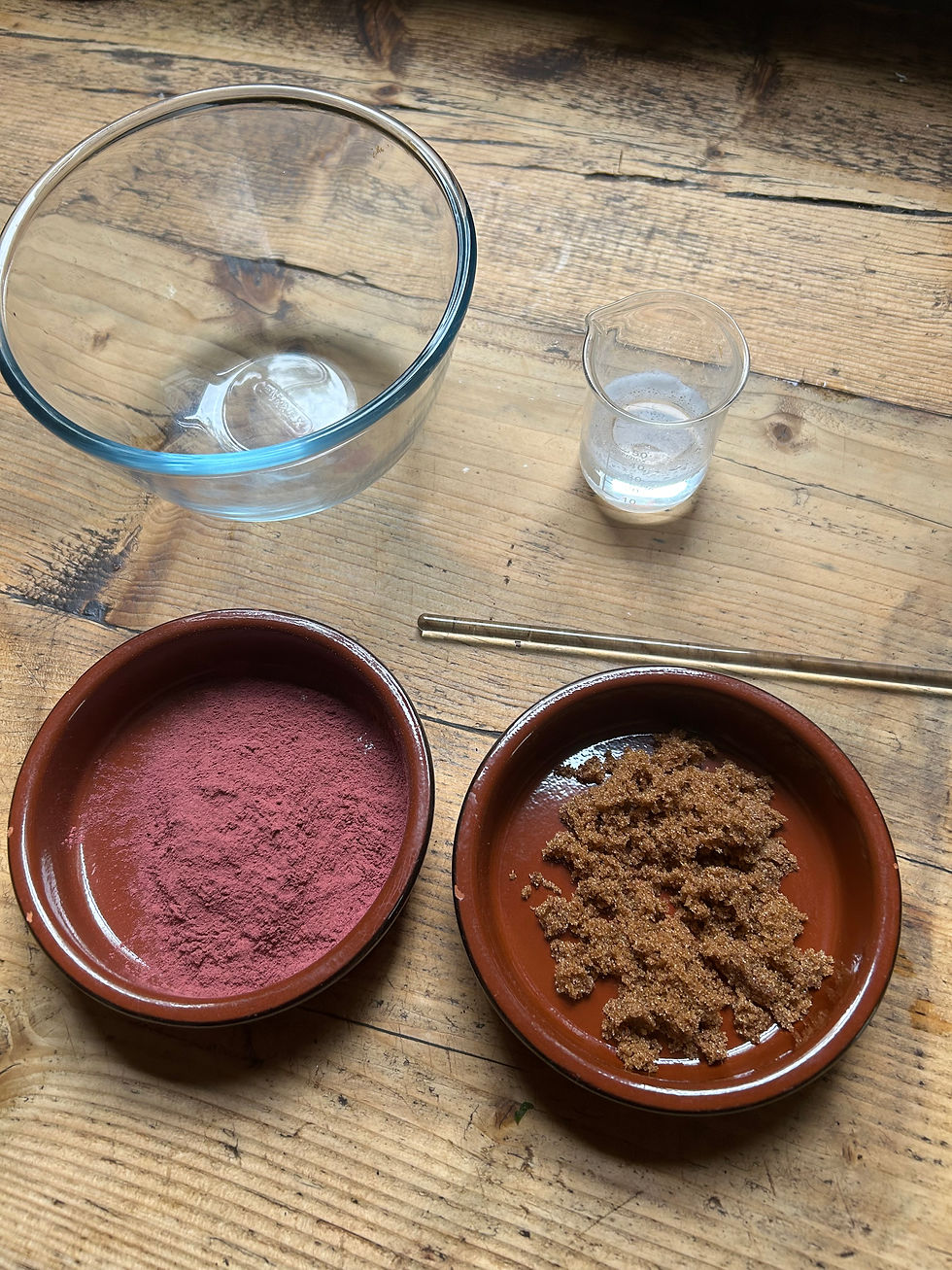 glass bowl, glass beaker with liquid in, tow terracotta pots with powder and sugar in on wooden surface