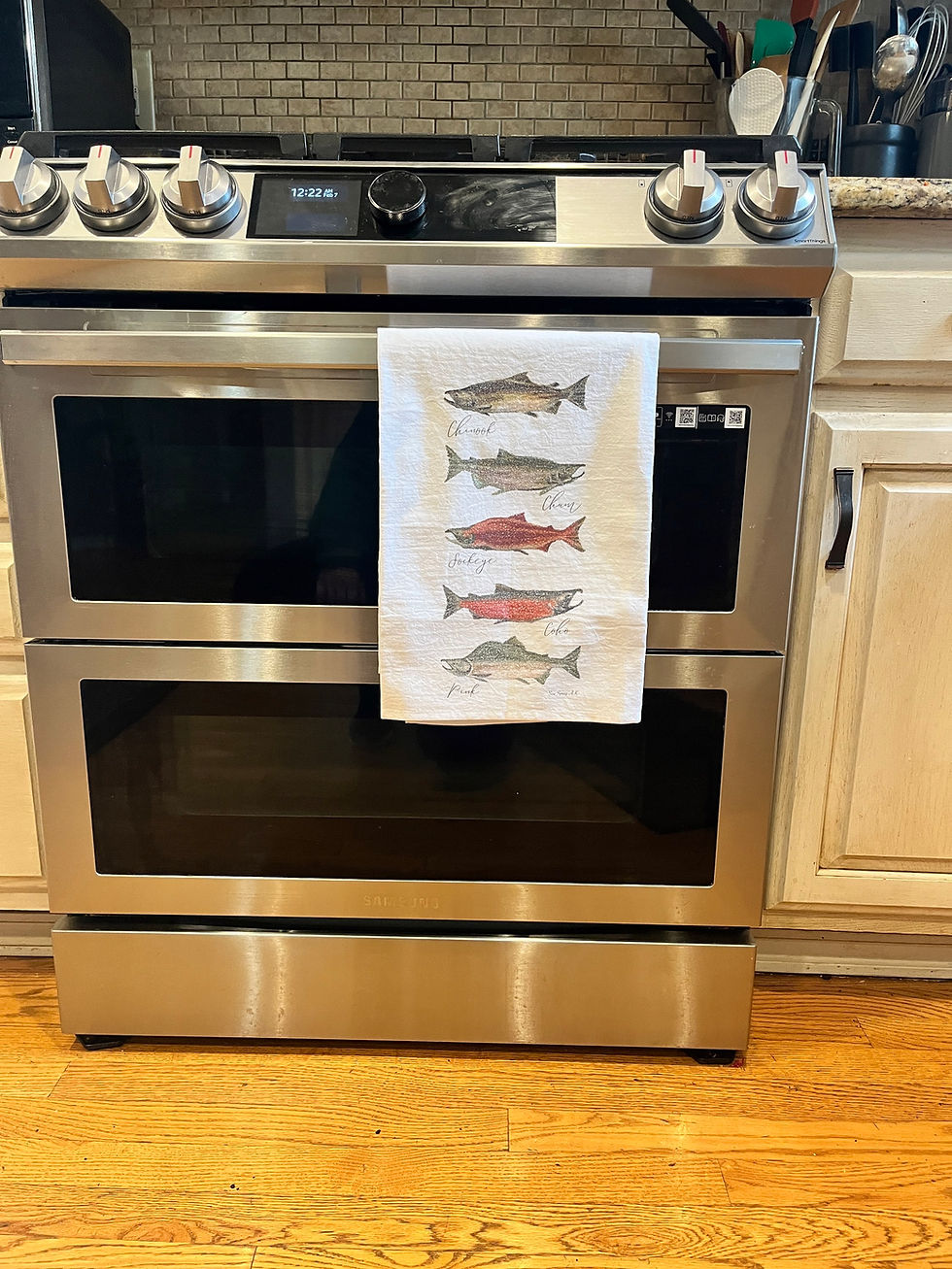 Thumbnail: Alaska Salmon Tea Towel hanging from kitchen oven