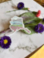 Alaska Glacier and Fireweed Sticker surrounded by purple flowers and green leaves