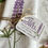 Thumbnail: a close up view of the lupine kitchen tea towel with twine and tag