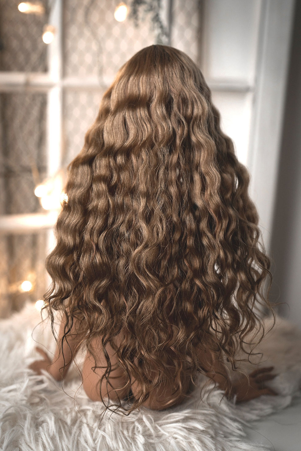 Handmade angora goat hair wig with a long curly lob.