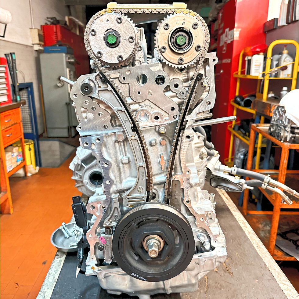 Close-up view of a Honda car engine being inspected in a workshop
