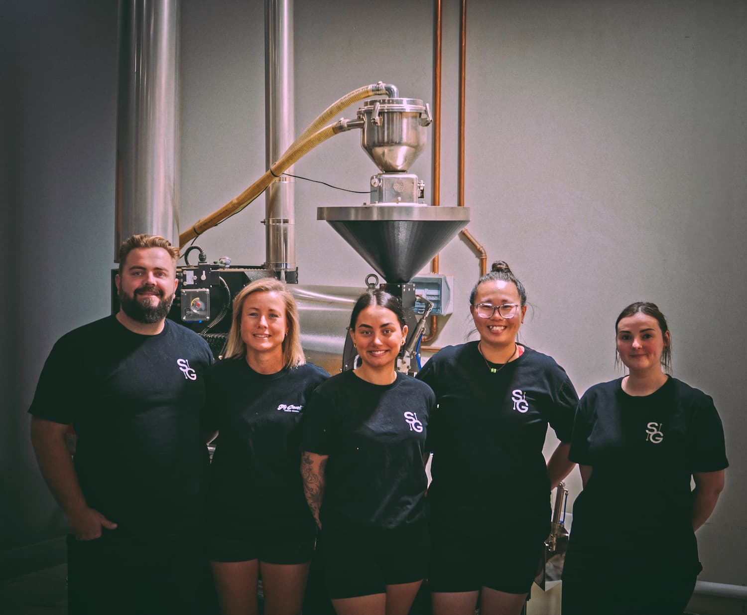 Stay Grounded staff standing in front of our roaster