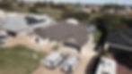 Roof repair crew working on house, solar panels visible