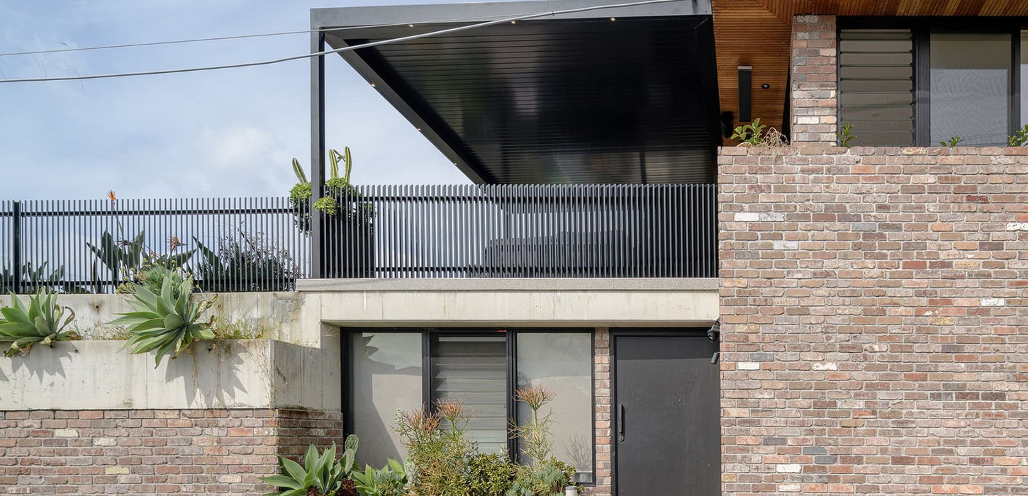 Modern brick home exterior with covered deck