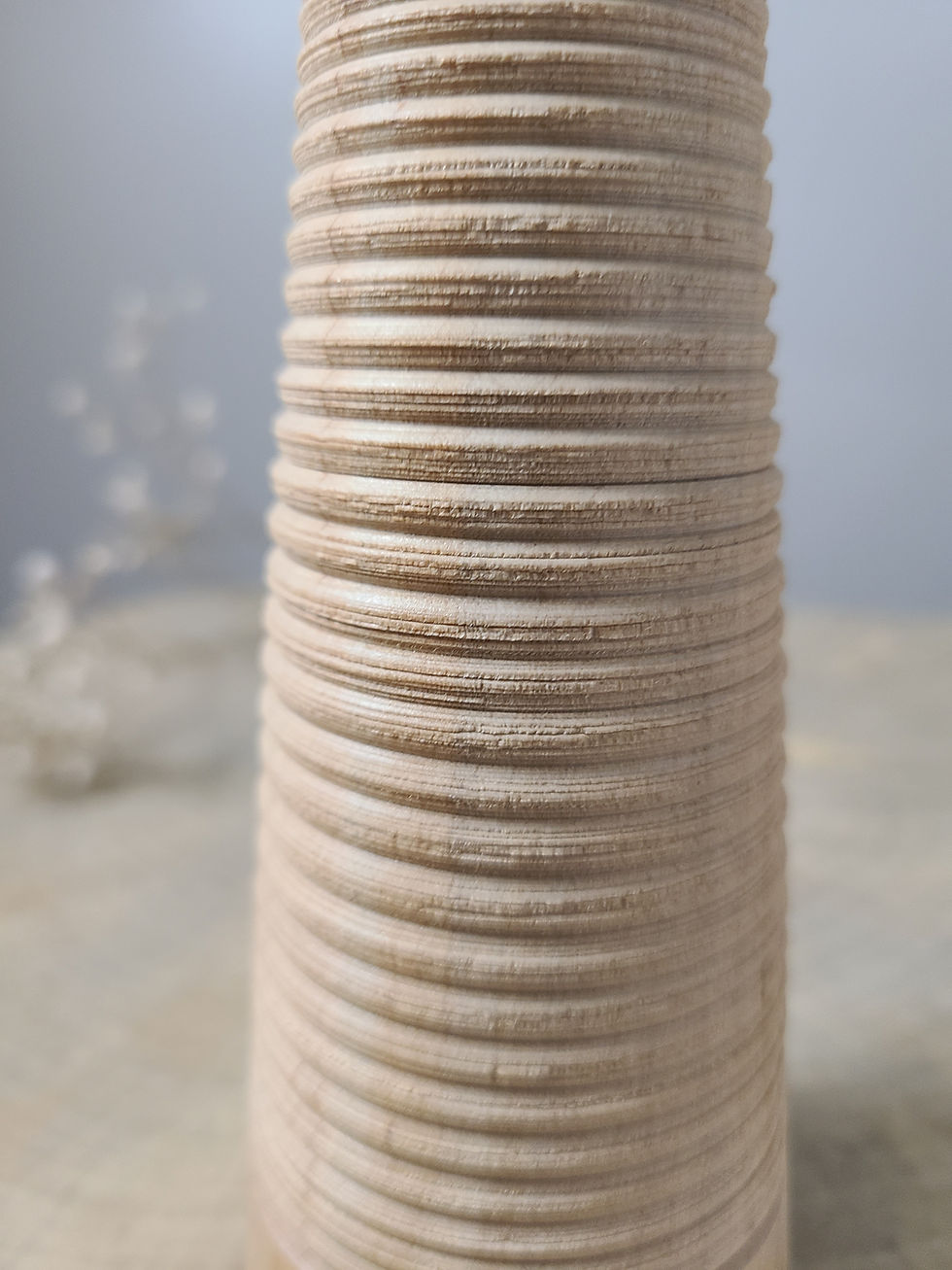Thumbnail: Handcrafted maple wood bud vase with vertical texture and minimalist conical shape, displayed on a rustic wood surface