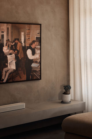 TV console in the living room of a Modern Organic 5-room home at 126C Tengah Drive, featuring a wire-free design against a limewash background, softly illuminated by natural light for a clean and seamless look.