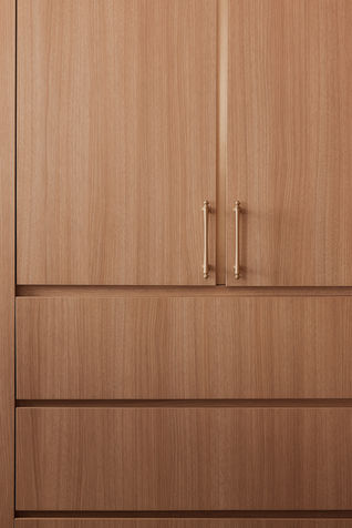 Wardrobe in the master bedroom of a modern classic resale flat at 202 Toa Payoh North, Singapore, featuring sleek, ergonomic handles for the wardrobe, designed for easy access and a minimalist aesthetic
