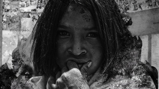A man clenching fist looking at camera. Black and white photo.