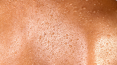 Photo of a woman's back with drops of water