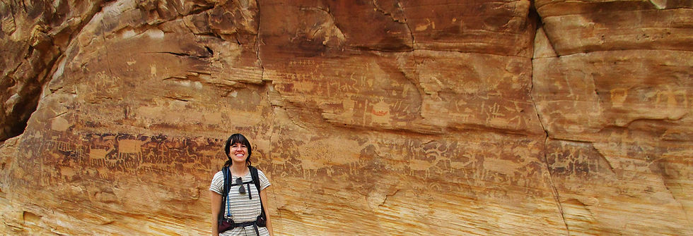 The author’s daughter Susi standing by a rock wall covered with petroglyphs at Gold Butte National Monument in southeastern Nevada. Photo courtesy of Joanne Urioste