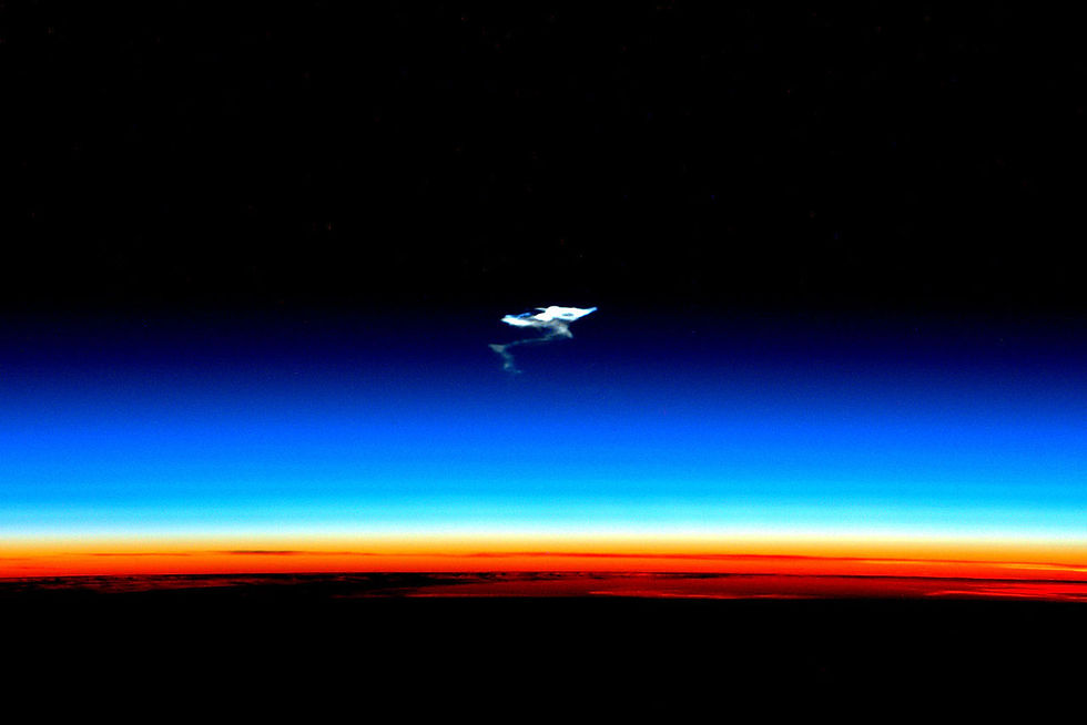 In this photo of Earth’s atmosphere (with a Soyuz craft reentering from space), the orange is the troposphere (rising to an average of about 40,000 feet) and the blue the stratosphere (extending to an average of some 100,000 feet above Earth), which is where climate geoengineers envision sulfur dioxide gas being released to form sun-reflective sulfate particles. ©NASA/Scott Kelly